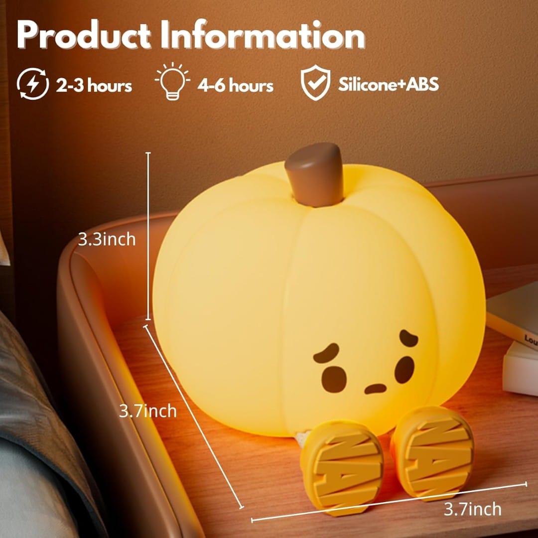 Soft silicone pumpkin lamp emitting warm light next to glass