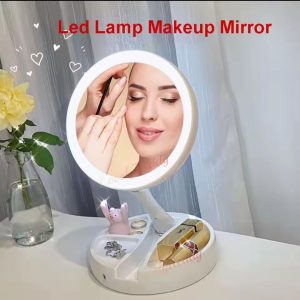 Person applying makeup using lit vanity mirror